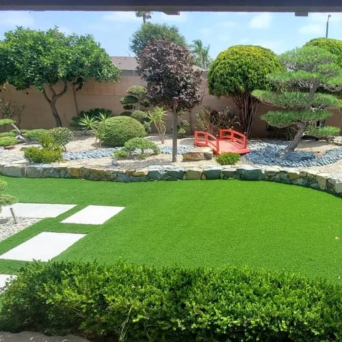 Backyard landscape design with hardscape, pavers and artificial grass at a home in Yorba Linda CA